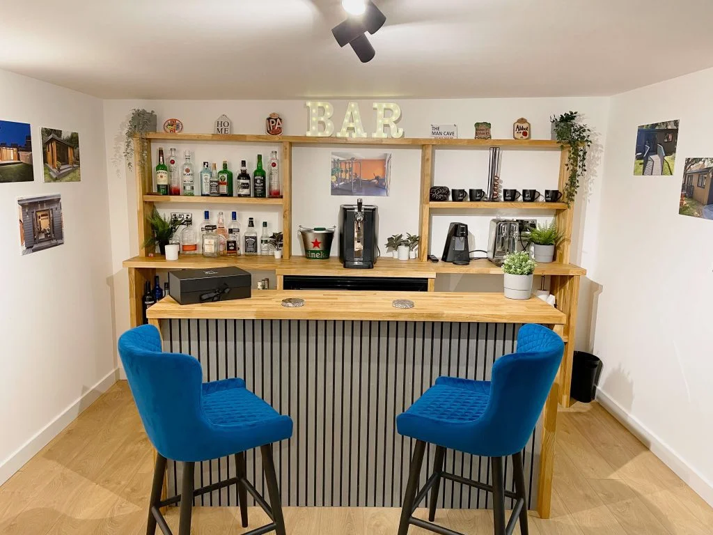 Interior garden bar setup with shelving and modern lighting
