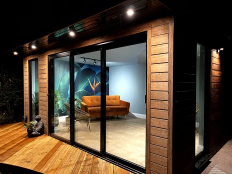 Modern garden room with wooden exterior and glass doors